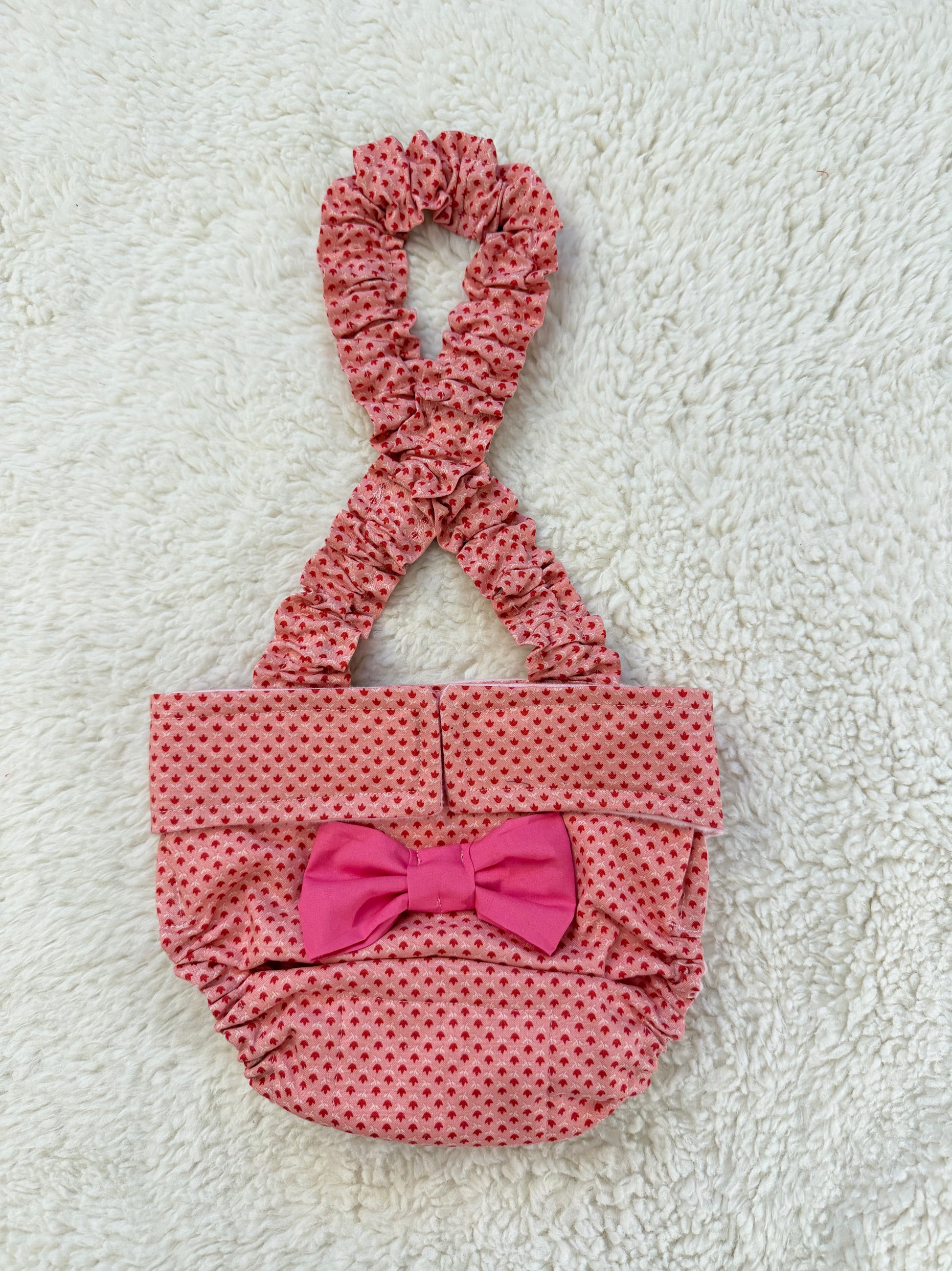coral pink dog diaper with a bow